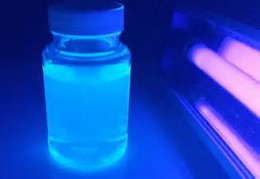 black light illuminating jar of liquid