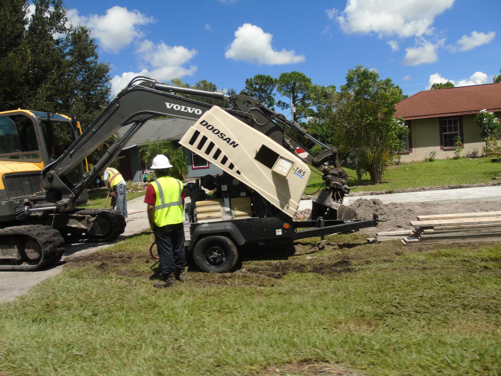 Repairing sidewalk and surrounding sod area.