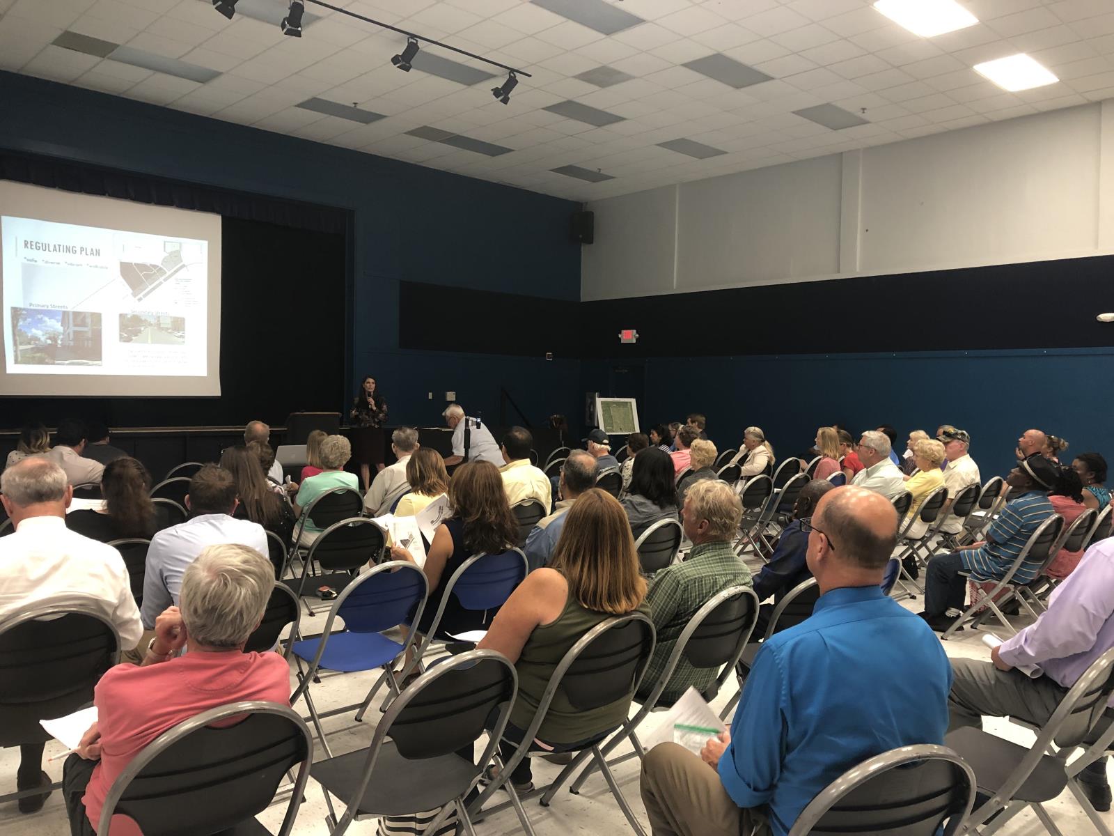 Image of a planner addressing a seated crowd