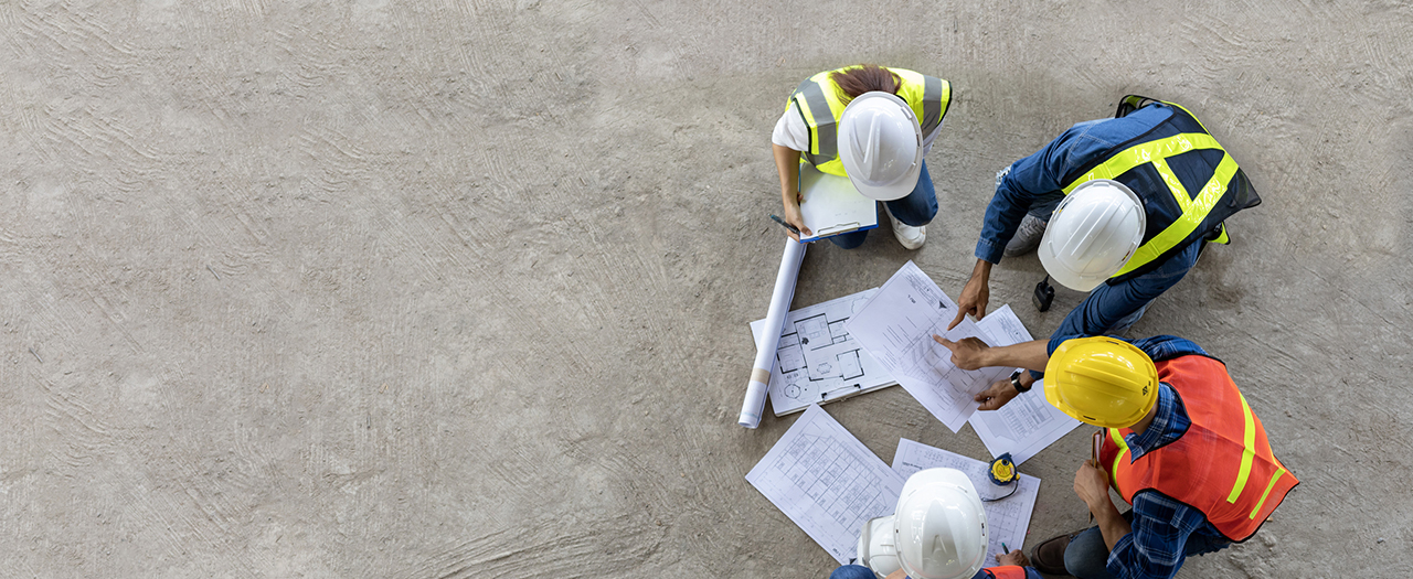 Group of workers reviewing site plans