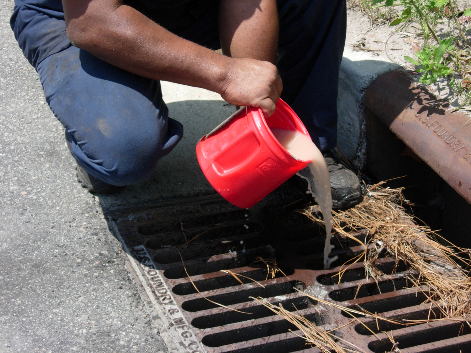 Man pouring down drain